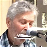 Jonathan Ochshorn playing harmonica in Cortland